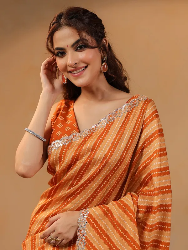 Orange printed silk saree with aabla accents