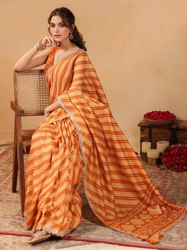 Orange printed silk saree with aabla accents