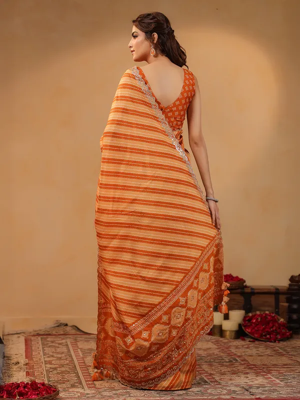 Orange printed silk saree with aabla accents