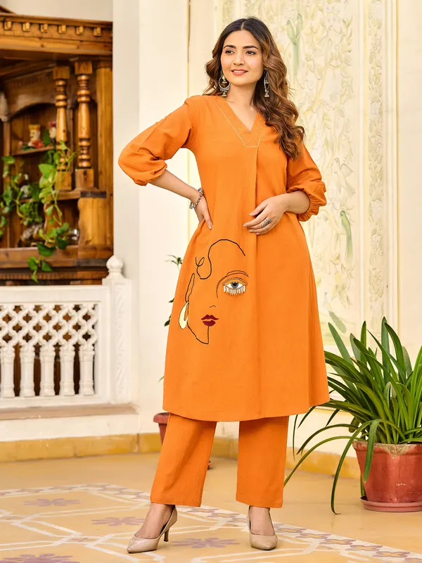 Orange silk ensemble with stone highlights