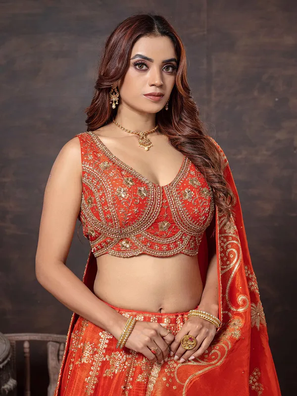 Orange sleeveless lehenga choli with dupatta