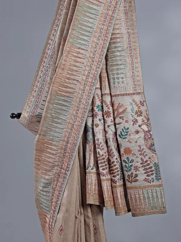 Pastel beige silk saree with intricate thread detailing