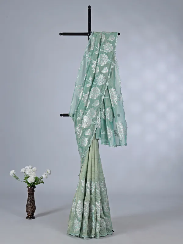 Pastel green semi tissue silk saree with elegant zari work