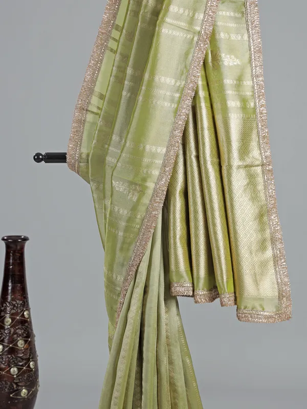 Pastel green soft tissue saree with sequin shine