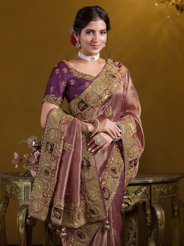 Pastel wine organza saree with heavy embellishment