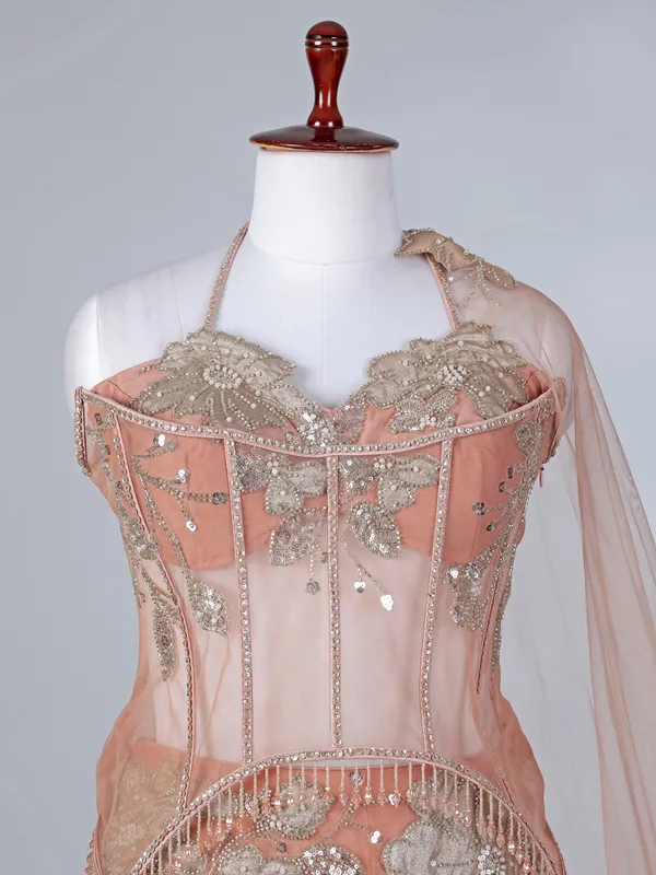 Peach net lehenga choli with attached dupatta