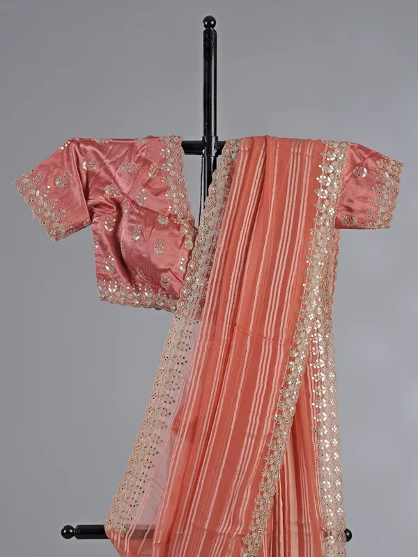 Peach organza satin silk saree with traditional embellishments