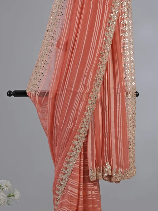 Peach organza satin silk saree with traditional embellishments