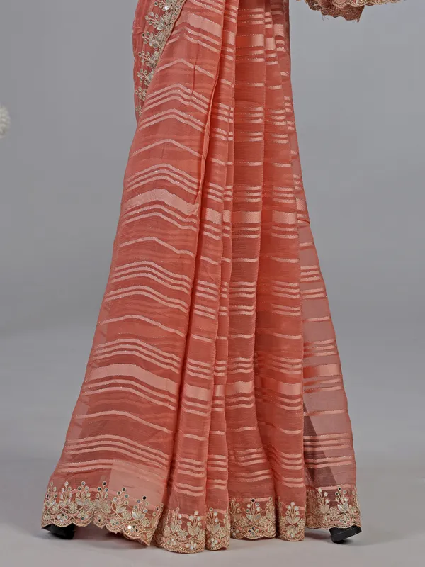 Peach organza satin silk saree with traditional embellishments