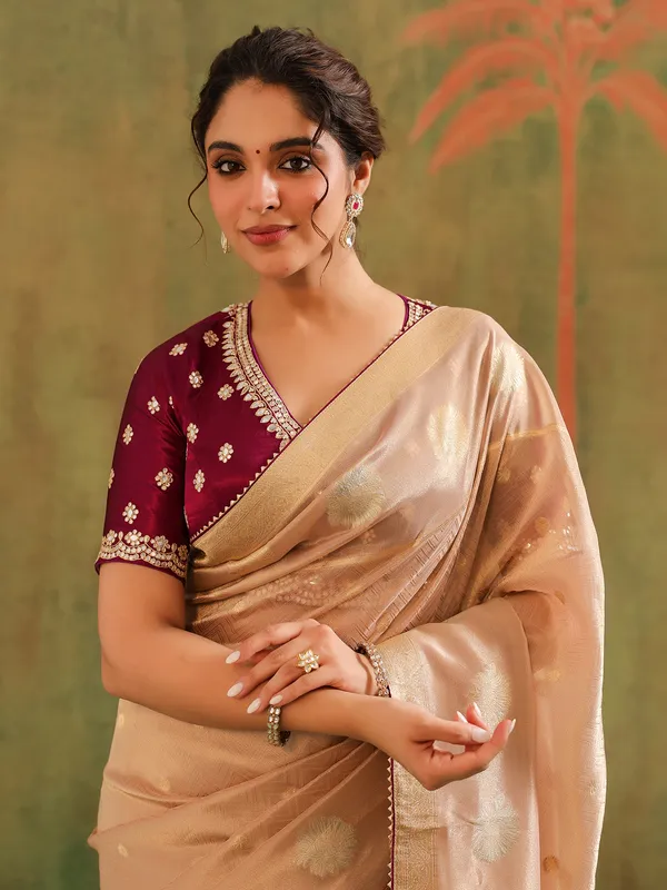 Peach silk saree with bold brown blouse wedding wear