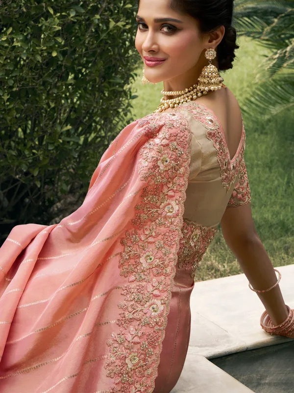 Peach tissue silk saree with zari and zardosi detailing