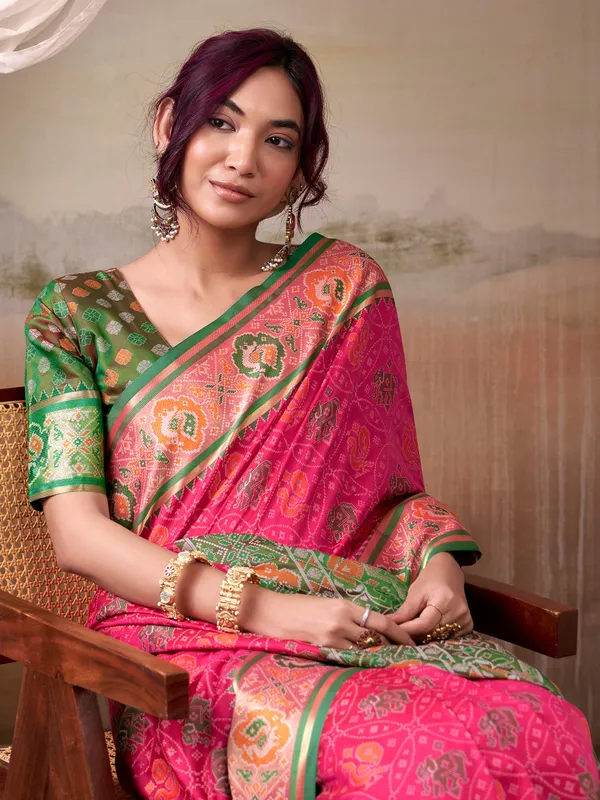 Pink patola silk saree with dark green blouse