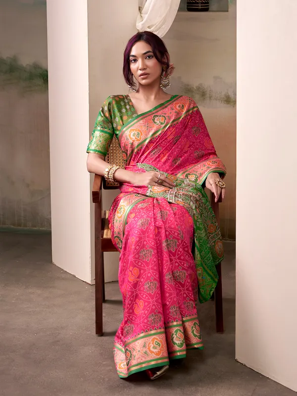 Pink patola silk saree with dark green blouse