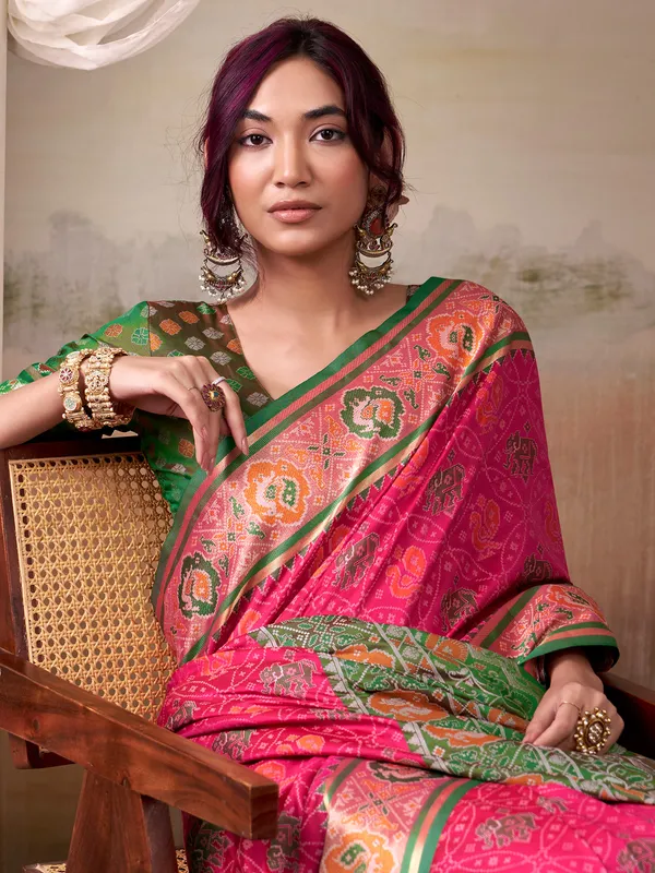 Pink patola silk saree with dark green blouse
