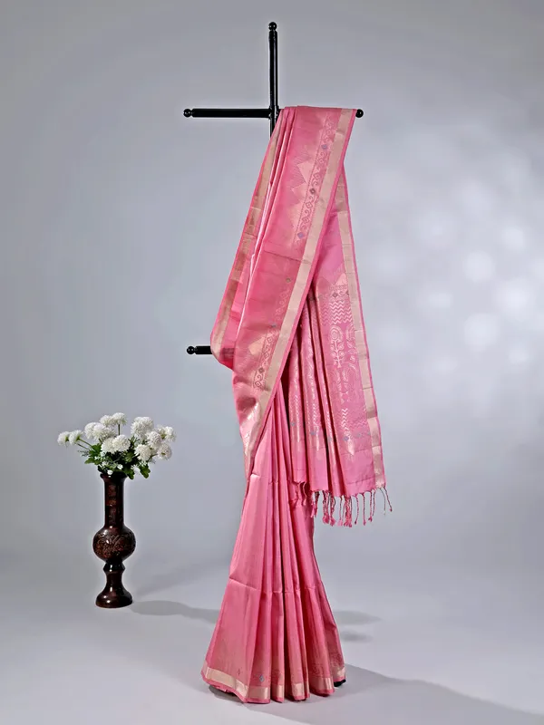Pink silk saree with gleaming zari accents