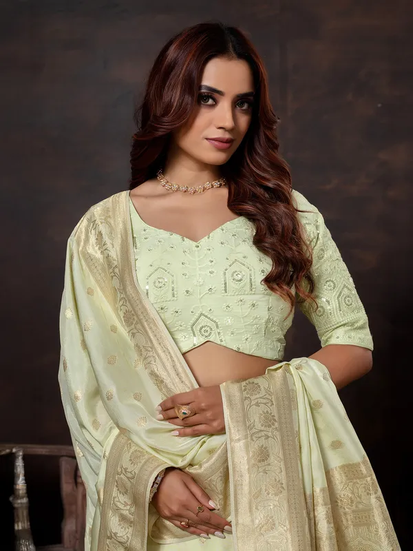 Pista green dola silk saree with zari glow