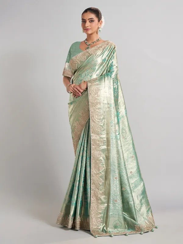Pista green kanjivaram silk saree with elegant zari work