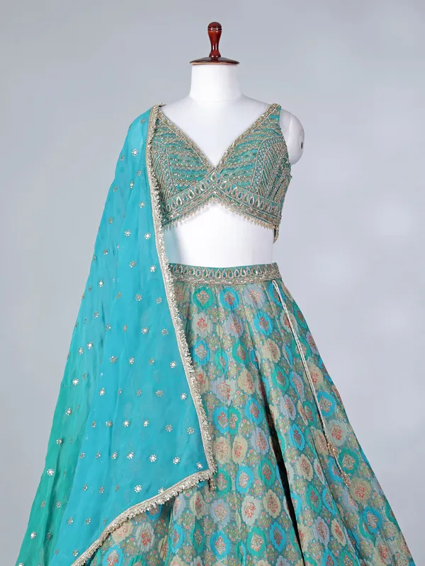 Rama green lehenga choli with colorful motifs