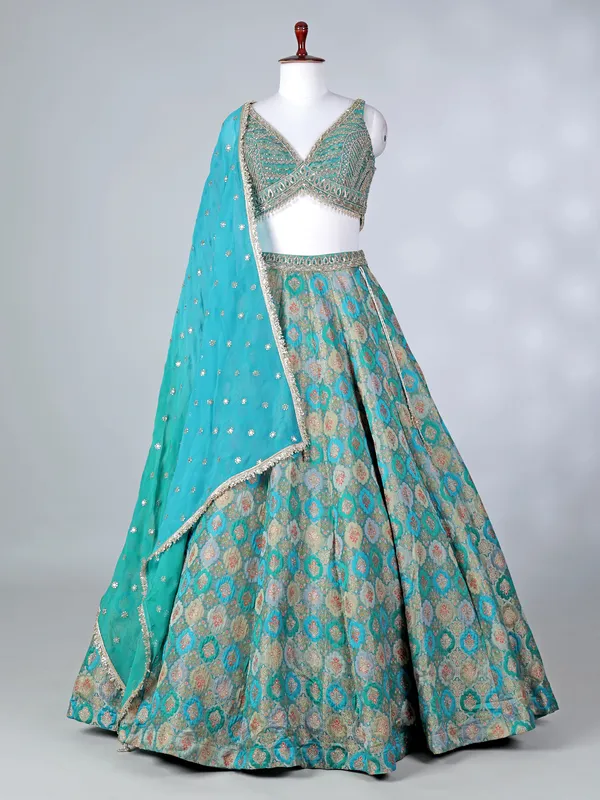 Rama green lehenga choli with colorful motifs