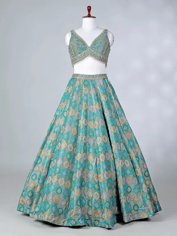 Rama green lehenga choli with colorful motifs