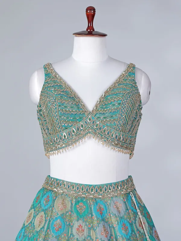 Rama green lehenga choli with colorful motifs