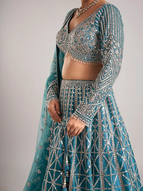 Rama green raw silk lehenga choli with mirror detailing