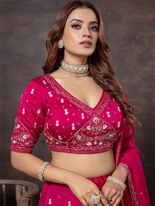 Rani color lehenga choli with elegant craftsmanship
