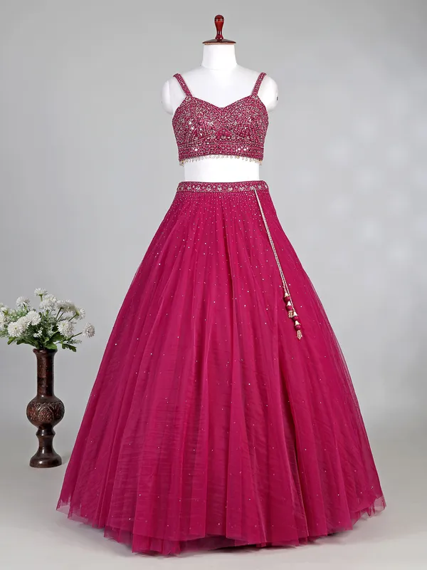 Rani pink net lehenga choli with diamond accents