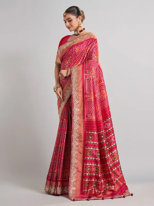 Rani pink patola silk saree with heavy bridal embellishments
