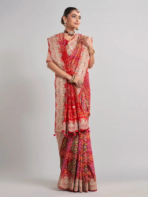 Red hyderabadi patola silk saree with a royal bridal look