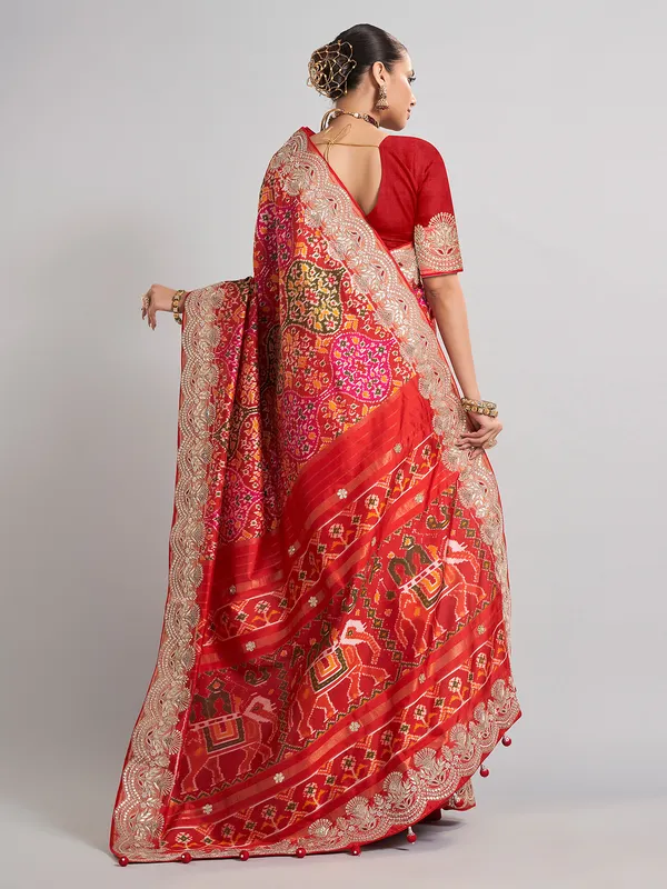 Red hyderabadi patola silk saree with a royal bridal look