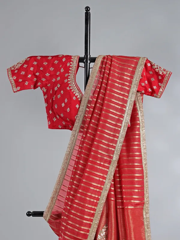 Red organza saree with traditional highlights