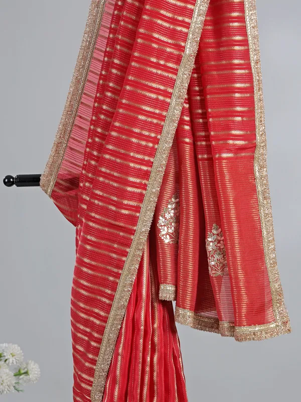 Red organza saree with traditional highlights