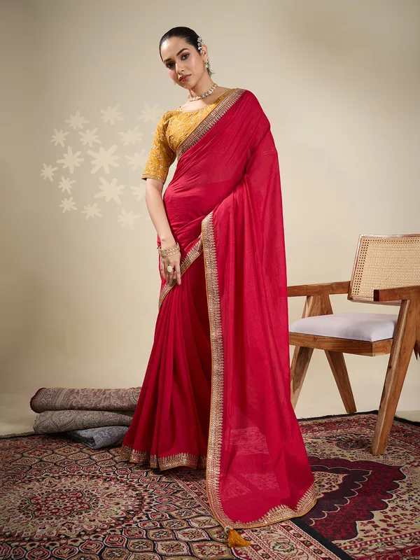 Red plain silk saree with embellished border