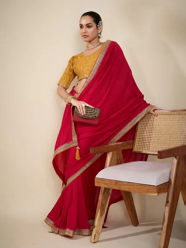 Red plain silk saree with embellished border