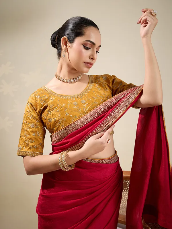 Red plain silk saree with embellished border