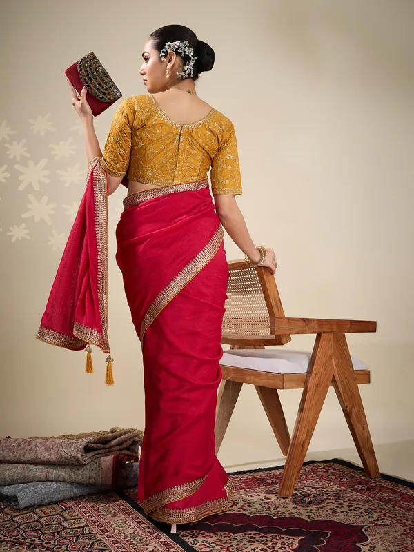 Red plain silk saree with embellished border