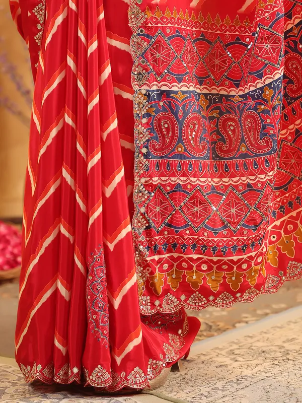 Red printed silk saree with aabla and resham work