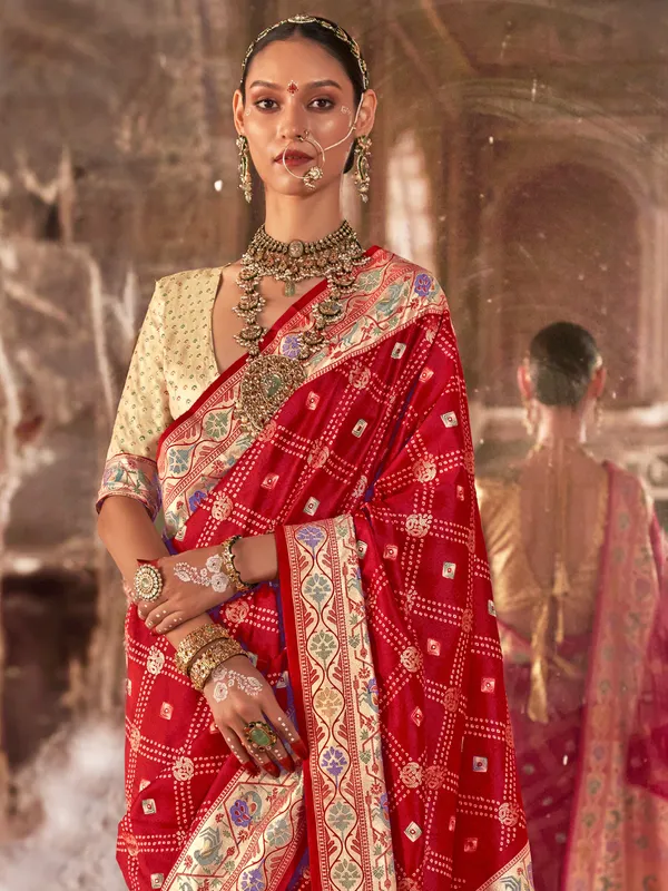 Red silk saree featuring luxe zari and print