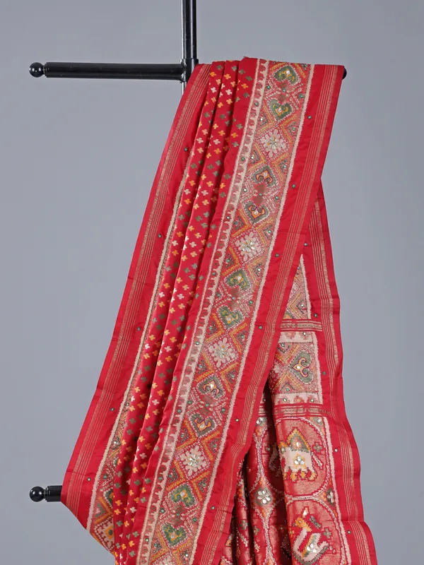 Red silk saree with colorful motifs