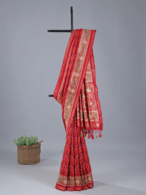 Red silk saree with colorful motifs