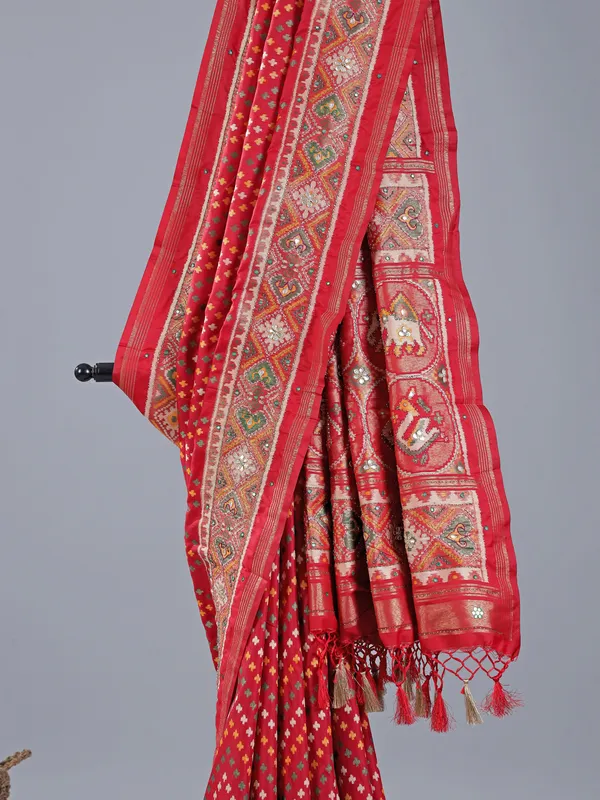 Red silk saree with colorful motifs