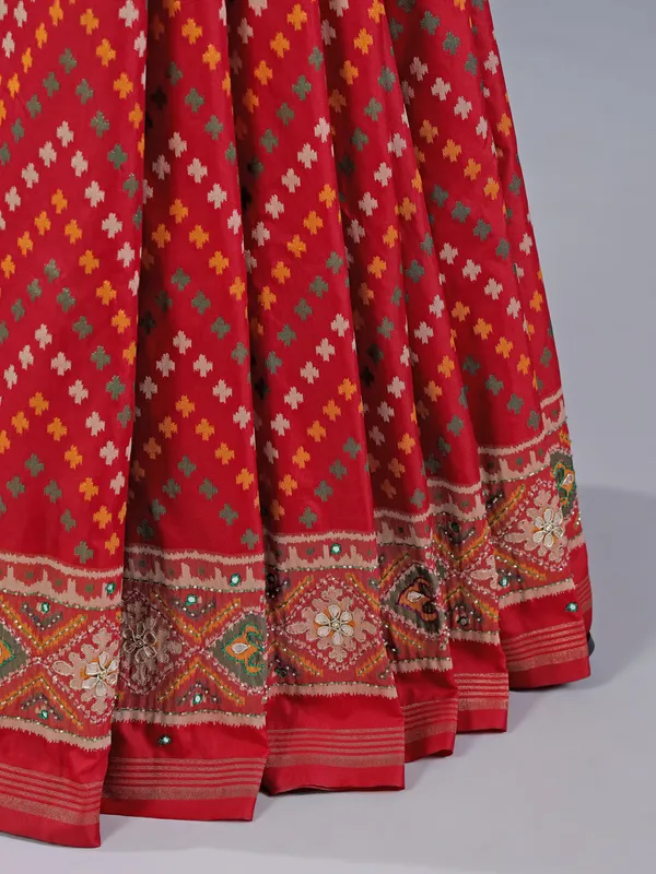 Red silk saree with colorful motifs