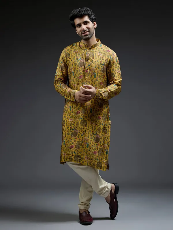 Rich mahendi yellow silk kurta suit in applique print