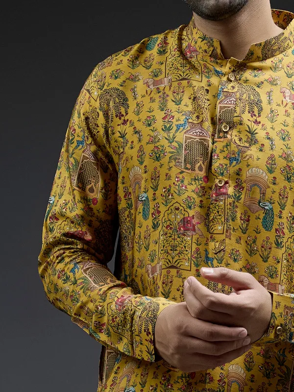 Rich mahendi yellow silk kurta suit in applique print