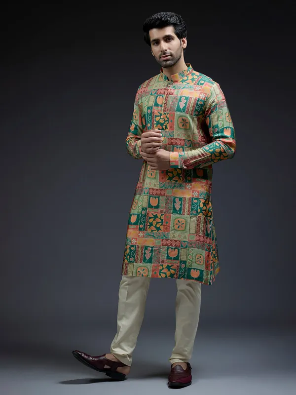 Rich silk green kurta suit in unique ethnic print