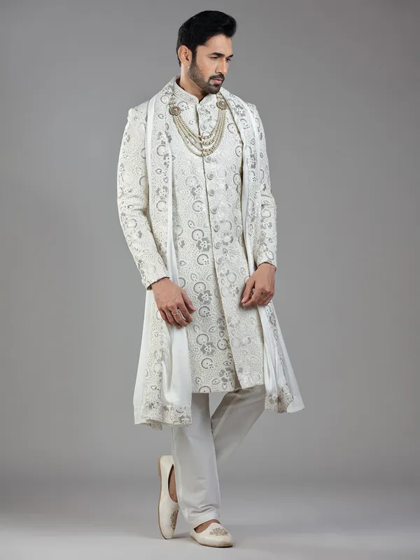 Royal splendor in cream silk with intricate embellishments and rich detailing