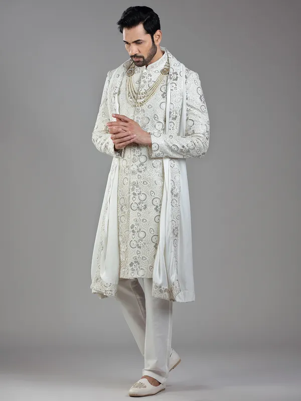 Royal splendor in cream silk with intricate embellishments and rich detailing