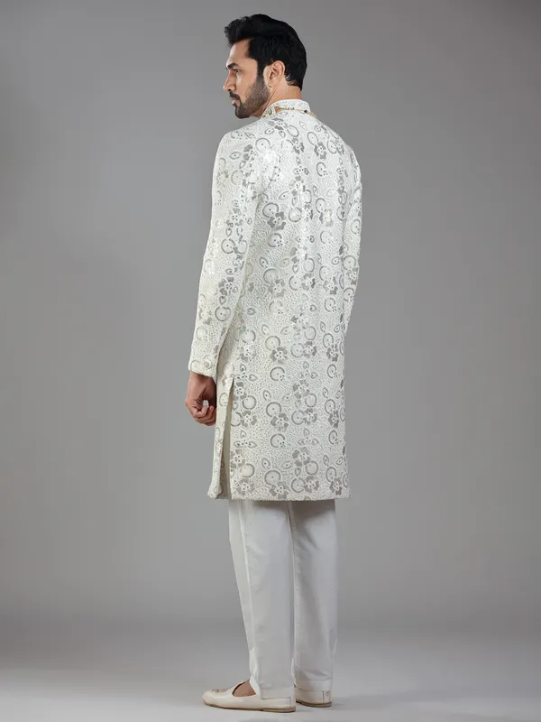 Royal splendor in cream silk with intricate embellishments and rich detailing