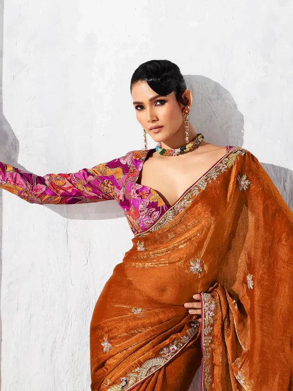 Rust orange tissue silk saree accented with resham work